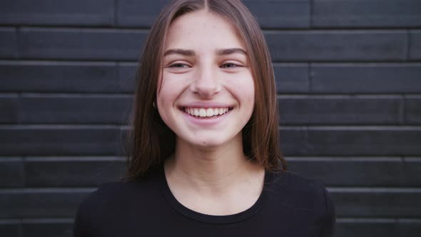 Portrait of Beautiful Young Woman with Attractive Smile