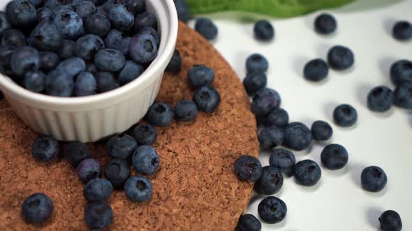 Blueberries Lying on the Table and in a White Bowl. View From the Top