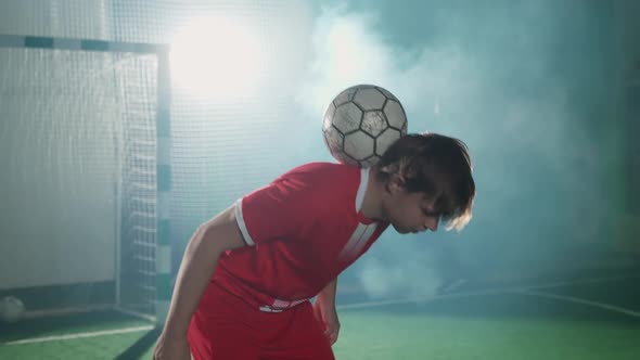 Professional Football Player Performs Tricks with a Soccer Ball Balances the Ball on Head Slow