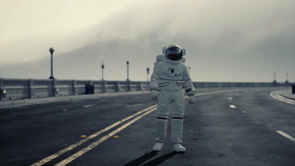 Astronaut Walks in the Middle of a Road alt