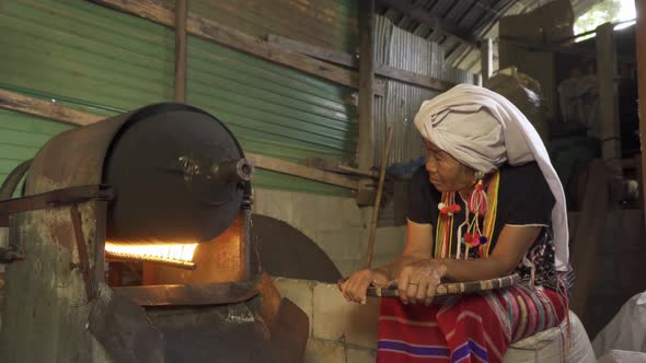 A karen tribe woman roasting coffee beans by using traditional local coffee