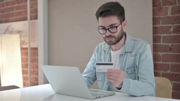 Young Male Designer Reacting To Online Payment Failure on Laptop 