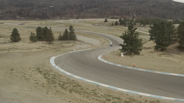 Exotic sports cars driving on a racing circuit, Osoyoos race track, Luxury Motorsports Club, Canada.