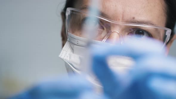 Female Doctor Flicking Syringe