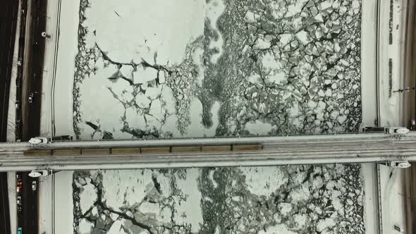 City Metro Train Passes Over the Bridge Over the Frozen Moscow River in Winter