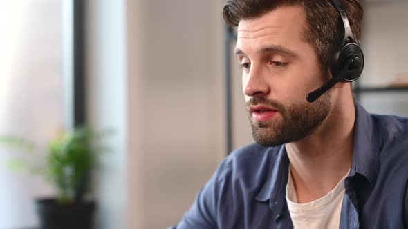 Smiling Young Bearded Guy Wearing Headset