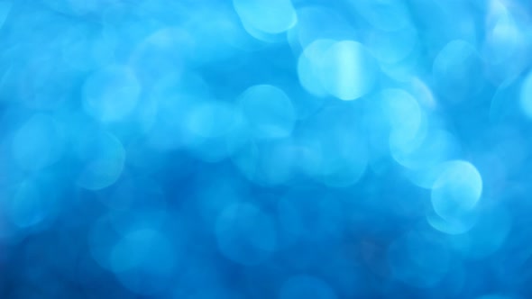 Blue abstract background of bokeh glitter lights