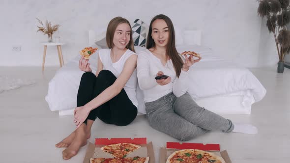 Girls Friends Eats Pizza and Watching TV at Home