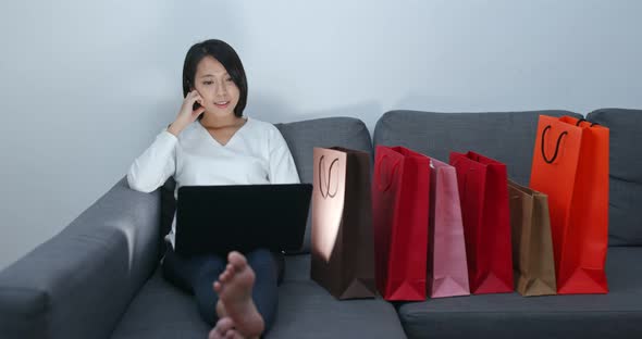 Woman make online shopping on laptop computer at home