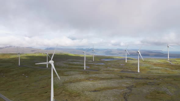 Drone Flight Among Wind Turbines In Green Landscape