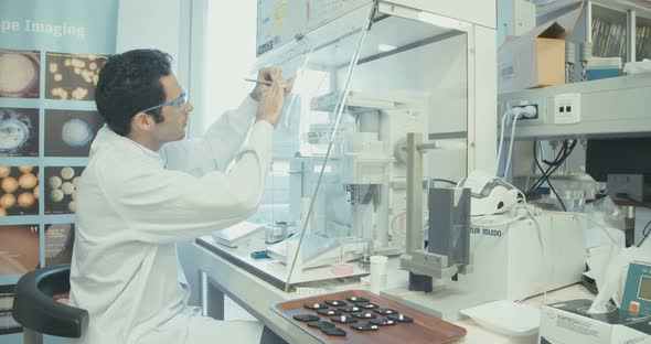 Scientist working in a pharmaceutical laboratory weighing chemicals