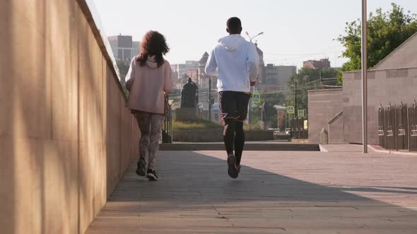 Friends Jogging Together In City Centre