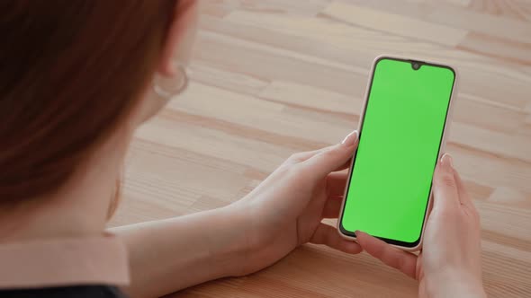 Handheld Camera: Point of View of woman Using Phone With Green Mock-up Screen Chroma Key