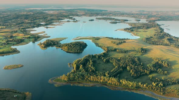 Aerial View Of Nedrava Lake And Green Forest Landscape In Sunny Summer Morning