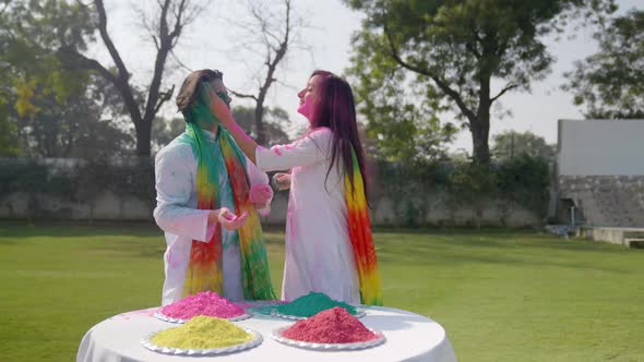 Attractive Indian couple playing Holi