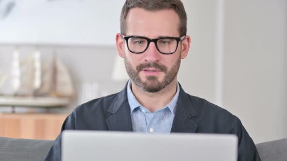 Close Up of Young Businessman Celebrating on Laptop