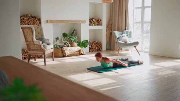 Woman in Sportswear Doing Fitness Exercises Help Her Instructor Online on Laptop