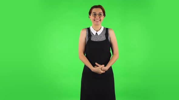 Funny Girl in Round Glasses Is Waiting in Anticipation with Pleasure. Green Screen