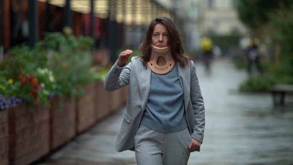 Adult Lady Is Walking in City, Wearing Cervical Collar for Curing Injury of Neck, Illness of Spinal