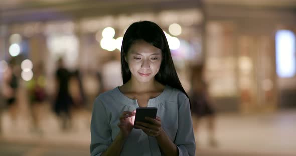 Woman use of mobile phone at night