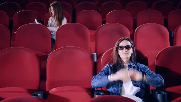 People Take Their Seats and Put on 3D Glasses in the Cinema