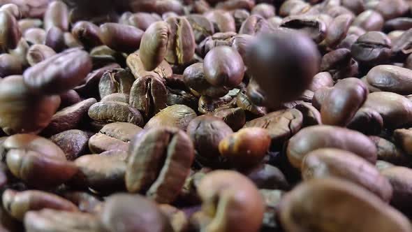 Close-up View of Roasted Arabica Coffee Beans Falling and Spinning