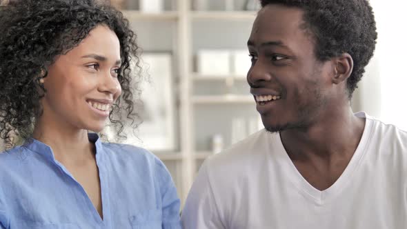 Smiling African Couple Looking at Eachother