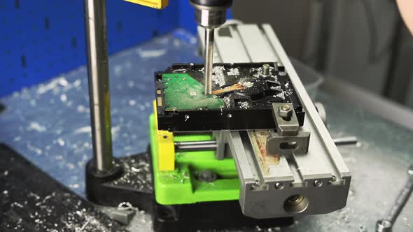 Drill Cuts Old Clamped Hard Disk Drive in Workshop