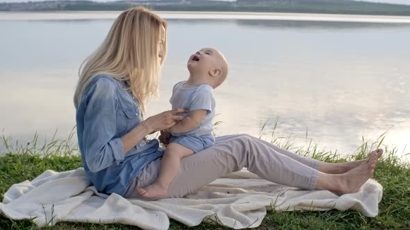 Mother Tickling Adorable Baby Boy alt