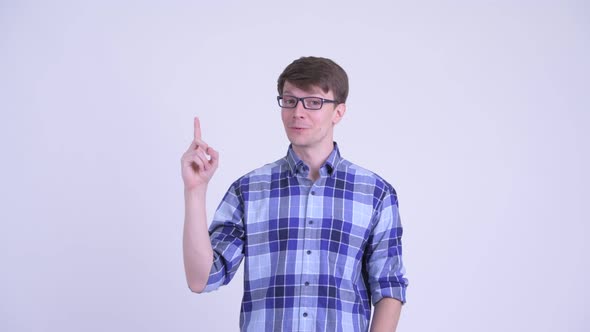 Happy Young Hipster Man Talking While Pointing Up