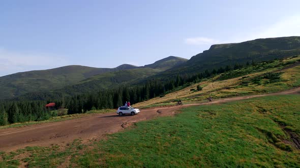 Couple Traveler on Suv Car Enjoying View of Carpathian Mountains