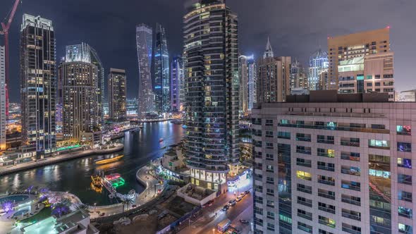 Aerial View of Dubai Marina Residential and Office Skyscrapers with Waterfront Night Timelapse