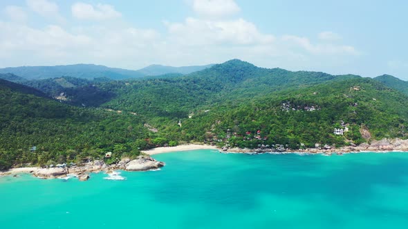 Jungle mountains on the Thailand island. Tropical sandy beach calm turquoise lagoon. Aerial panorama