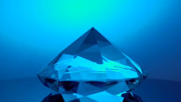 Diamond Rotating at Its Point Reflects Blue Light