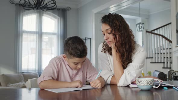 Young Mother And Son At The Table