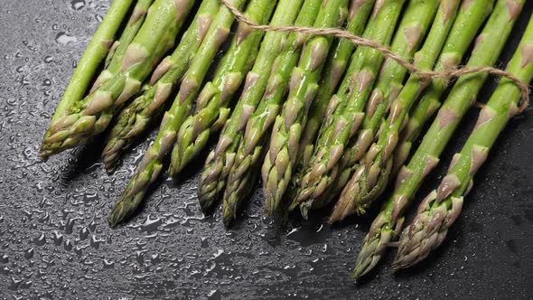 Raw Green Asparagus on Black Slate Background