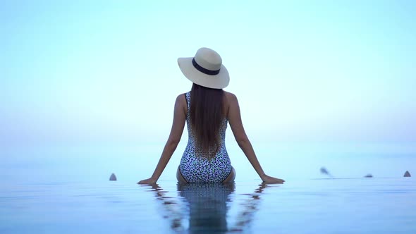 Young asian woman enjoy around outdoor swimming pool for leisure