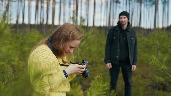 Girl Photographing a Man in the Forest