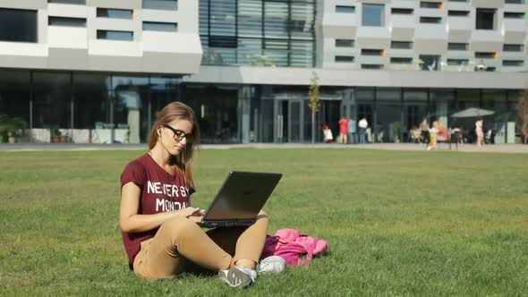 Woman Works on Grass