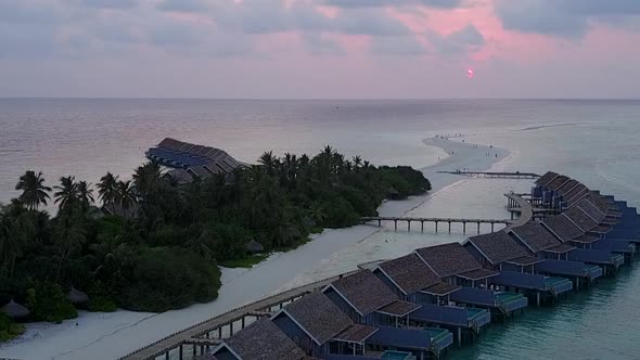 Aerial drone scenery of tourist beach by blue ocean with sand background