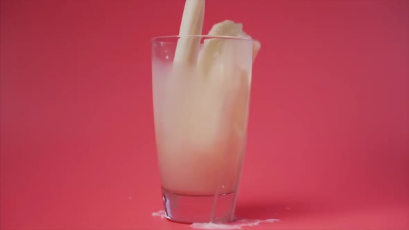 Pouring Milk Into a Glass with Splash