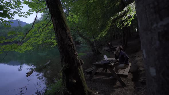 Businessman rejoices in the forest.