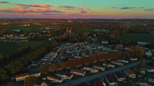 Aerial View of Mobile, Manufactured Homes and Fertile Farmlands and Farms at a Golden Hour Sunset