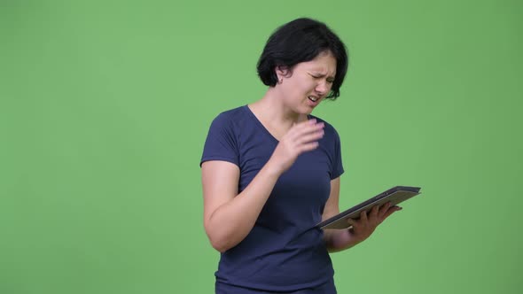 Beautiful Woman with Short Hair Using Digital Tablet