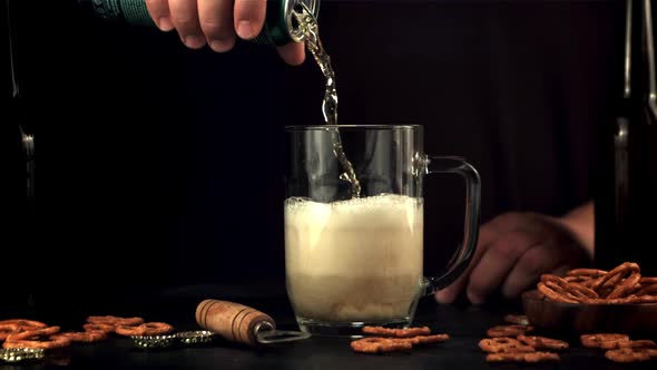 Super Slow Motion the Male Hand Pours Beer Into a Glass of Foam