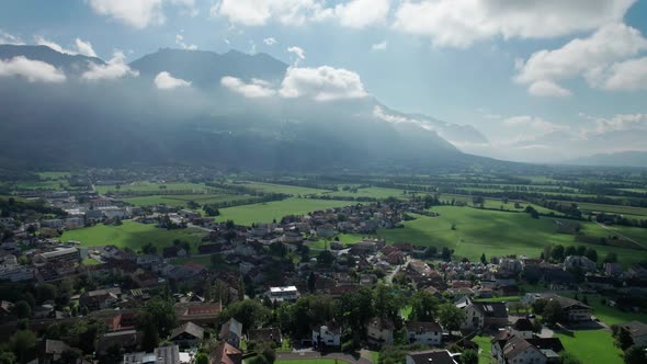 Aerial View of Liechtenstein with Houses on Green Fields in Alps Mountain Valley