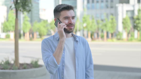 Young Man Talking on Phone While Standing Outdoor