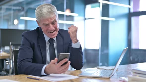 Upset Middle Aged Businessman Get Shocked on Cellphone