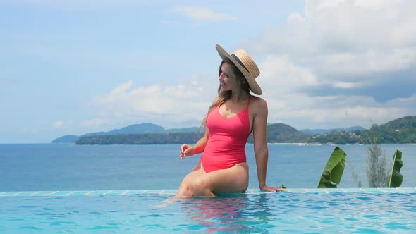 Woman on Tropical Vacation Relax in Swimming Pool at Luxury Hotel with Ocean