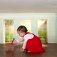 Toddler girl in small room with model house and key - VideoHive Item for Sale